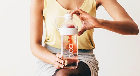 Photo: a woman holding a Drinkfinity reusable bottle